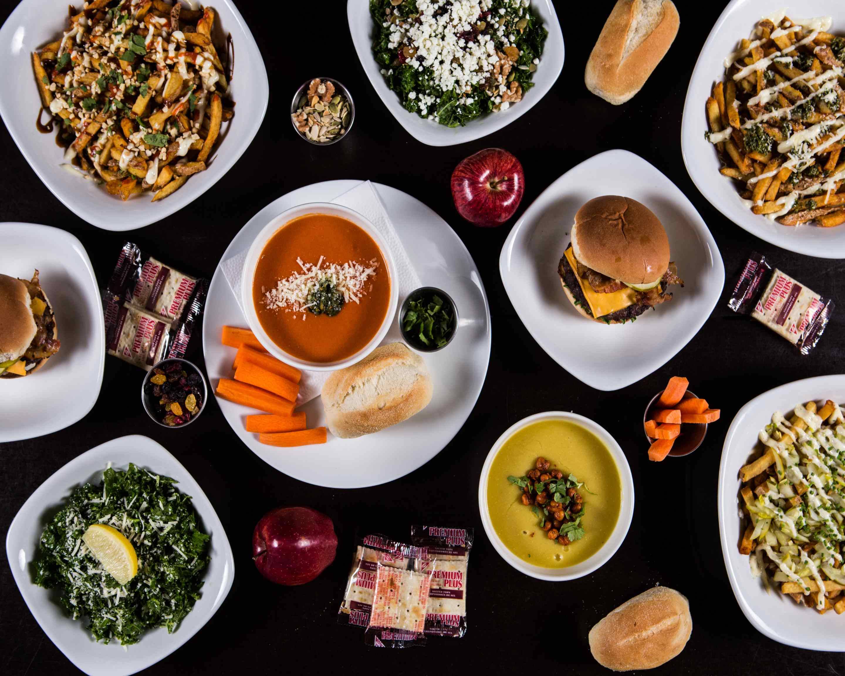 A Burnt Tongue feast of tomato soup, burgers, loaded fries, fresh salads, and bread